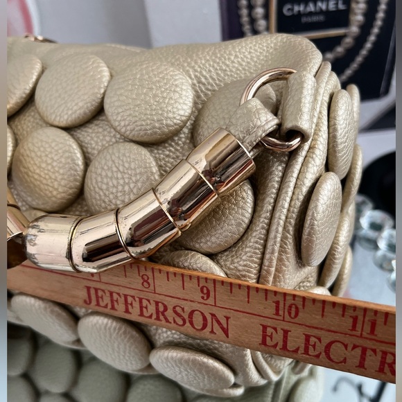 unique design with embossed circular details and a structured, metallic handle. - Picture 10 of 12